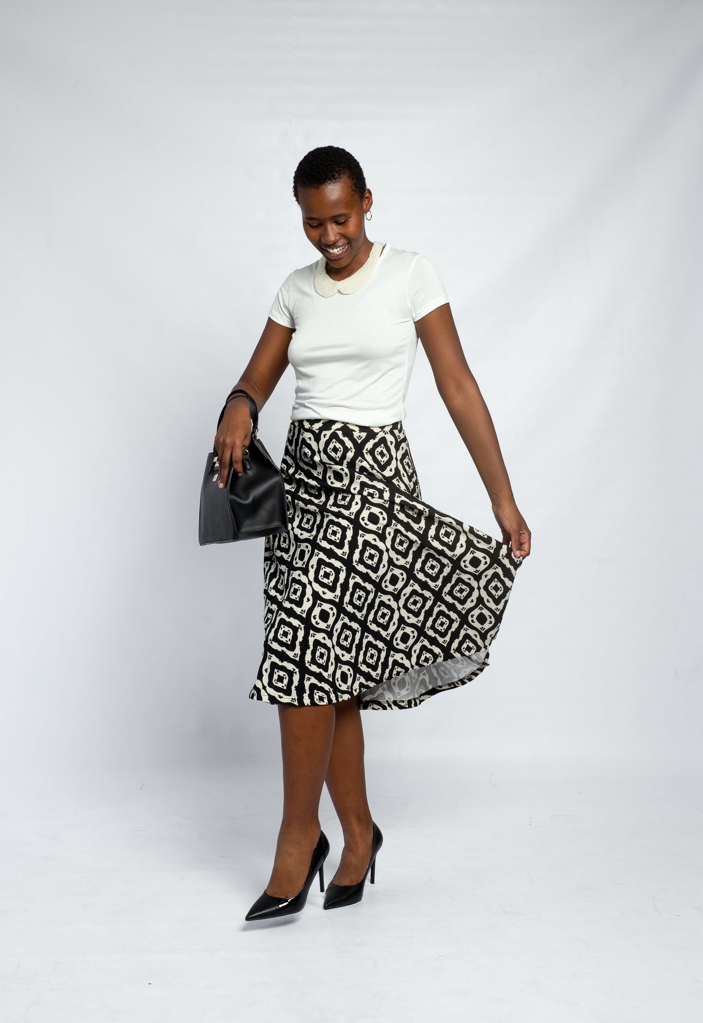 GLOW LADIES PRINTED PLEATED SKIRT-BLK | STON